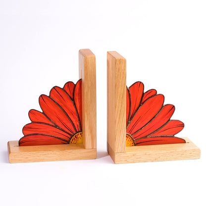 Two stained glass bookends with red gerbera flower designs on a white background, set on wooden bases.